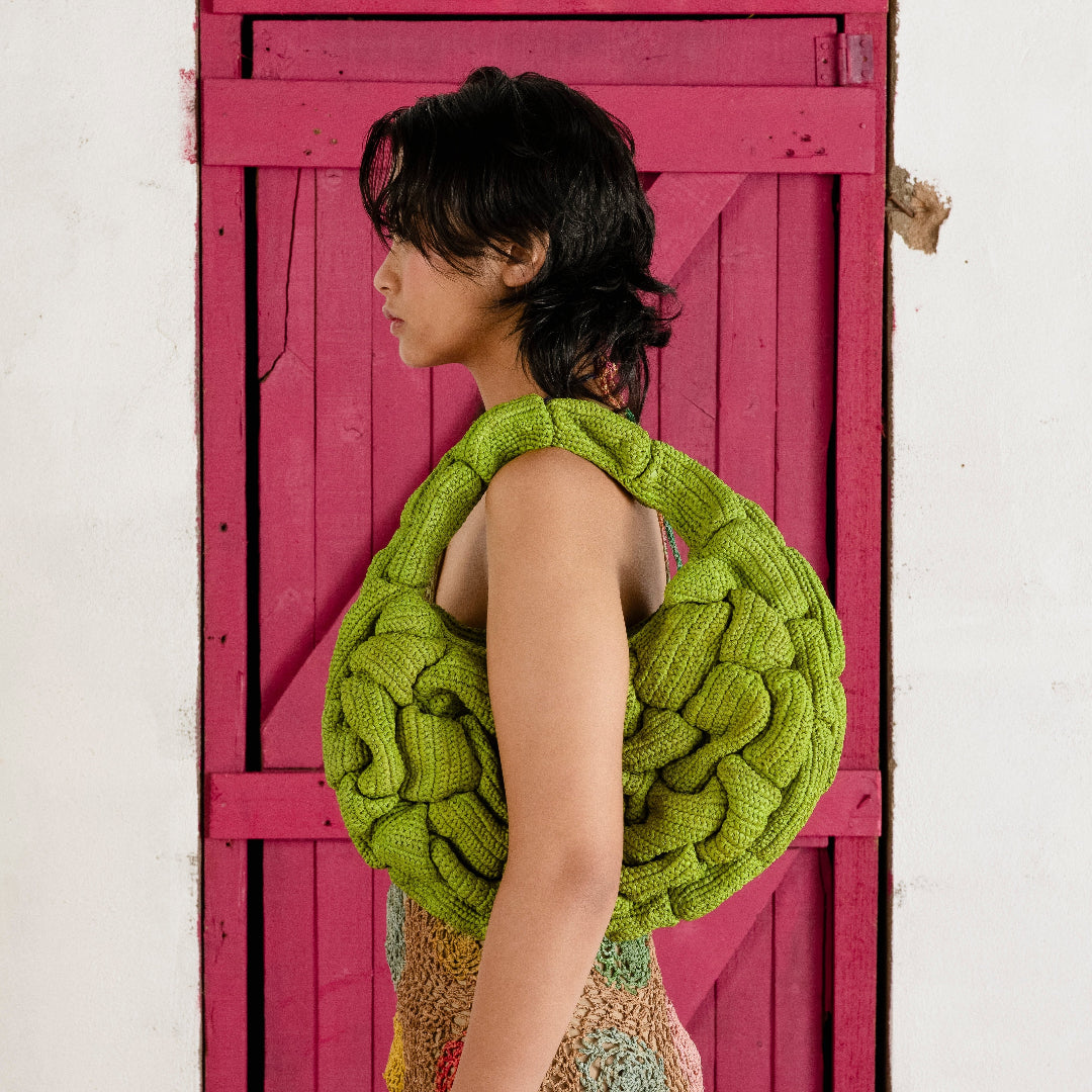 Woman with green Bombé bag